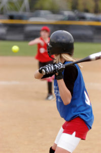 A softball player waits for the pitch.
