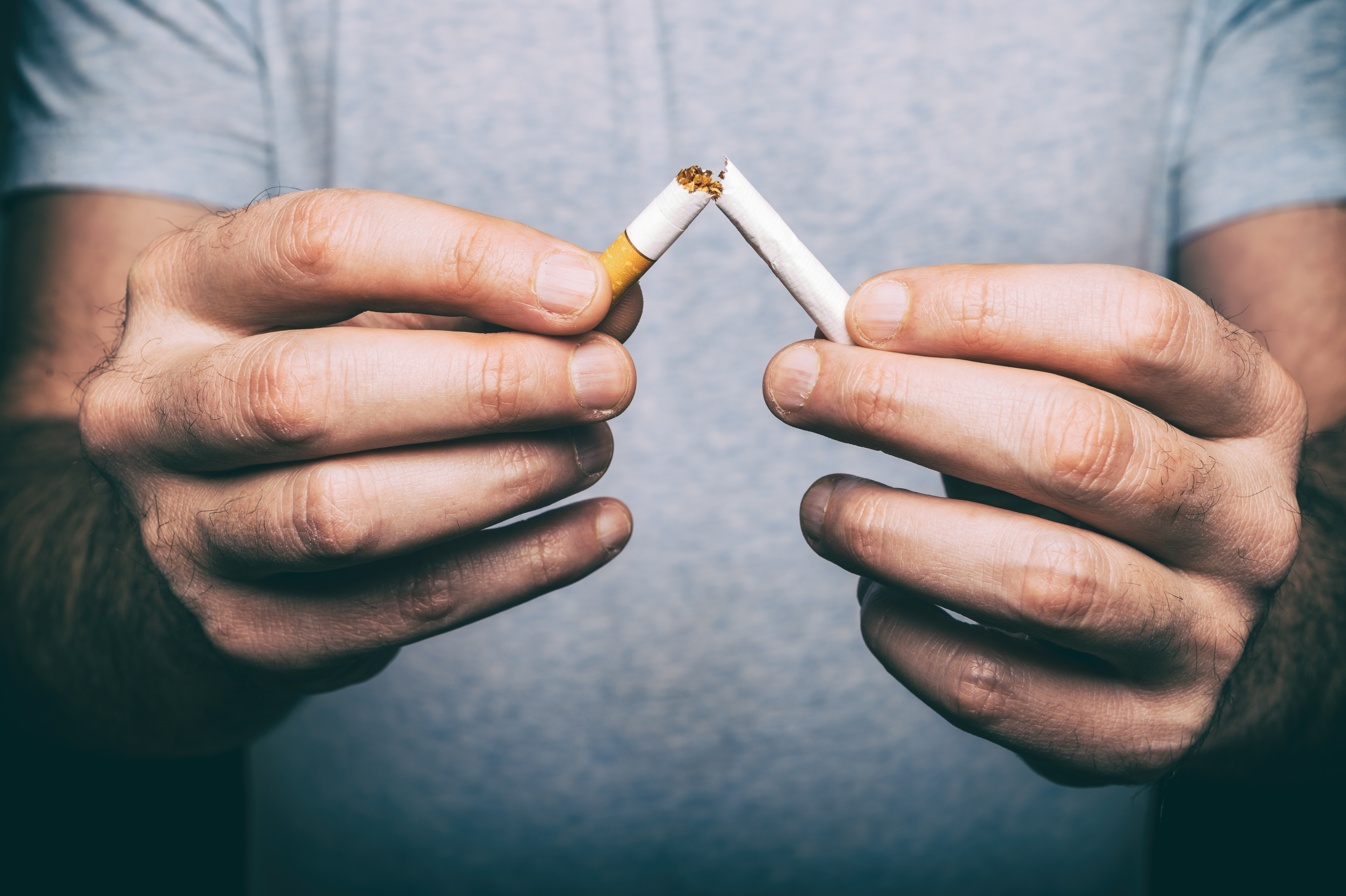 Quitting smoking - a boy crushing a cigarette